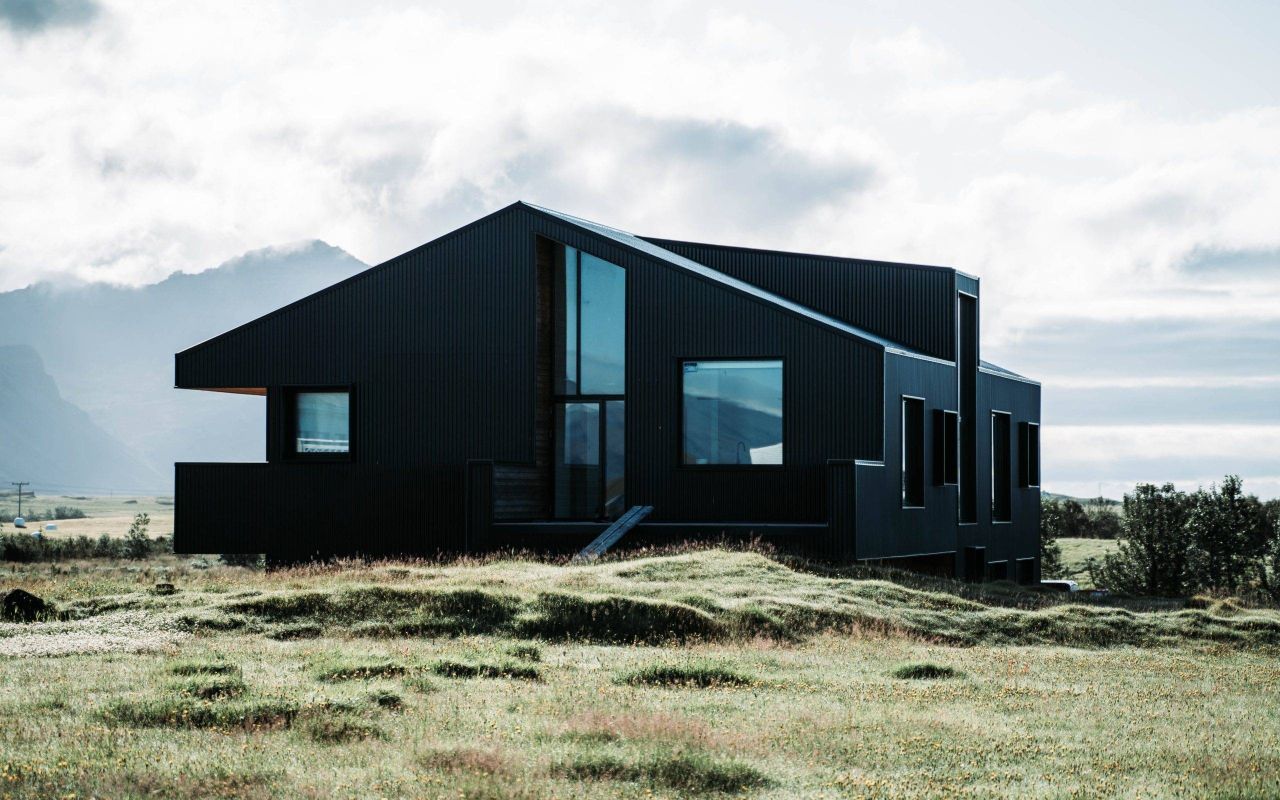 Black-house-in-the-middle-of-bare-land-73100-scaled